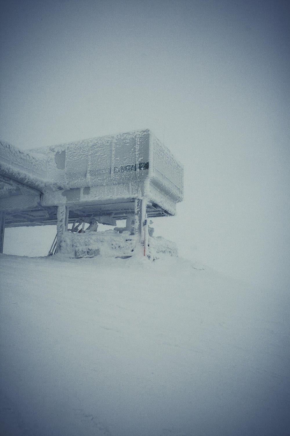 a building on a hill covered in snow