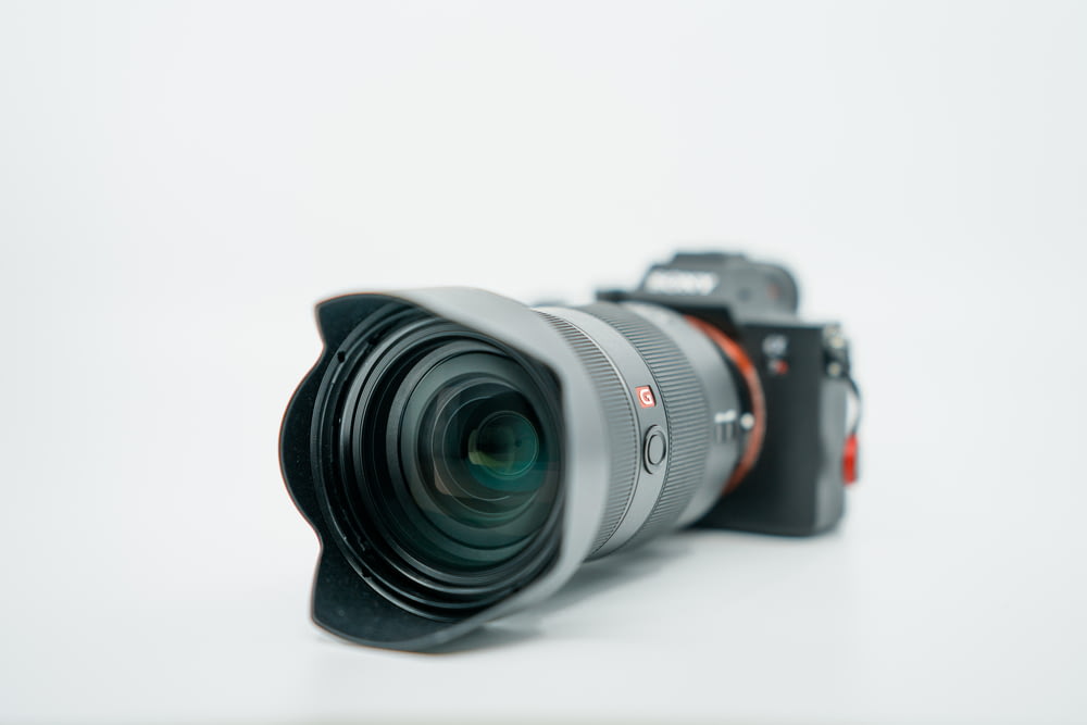 black DSLR camera on white surface