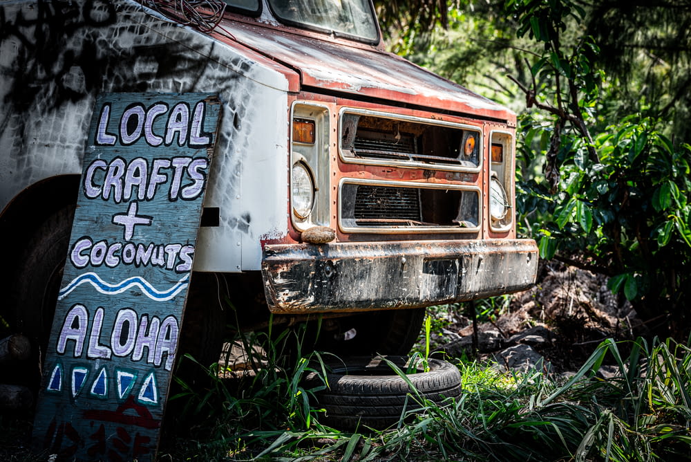 Local Crafts Coconuts Alohoa sign beside truck