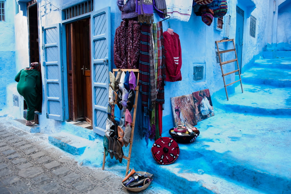 hanged assorted-colored clothes beside wall