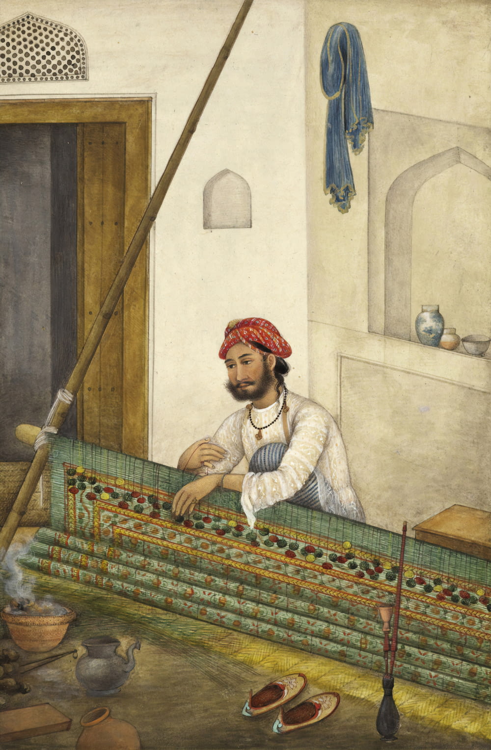 man sitting beside wall painting