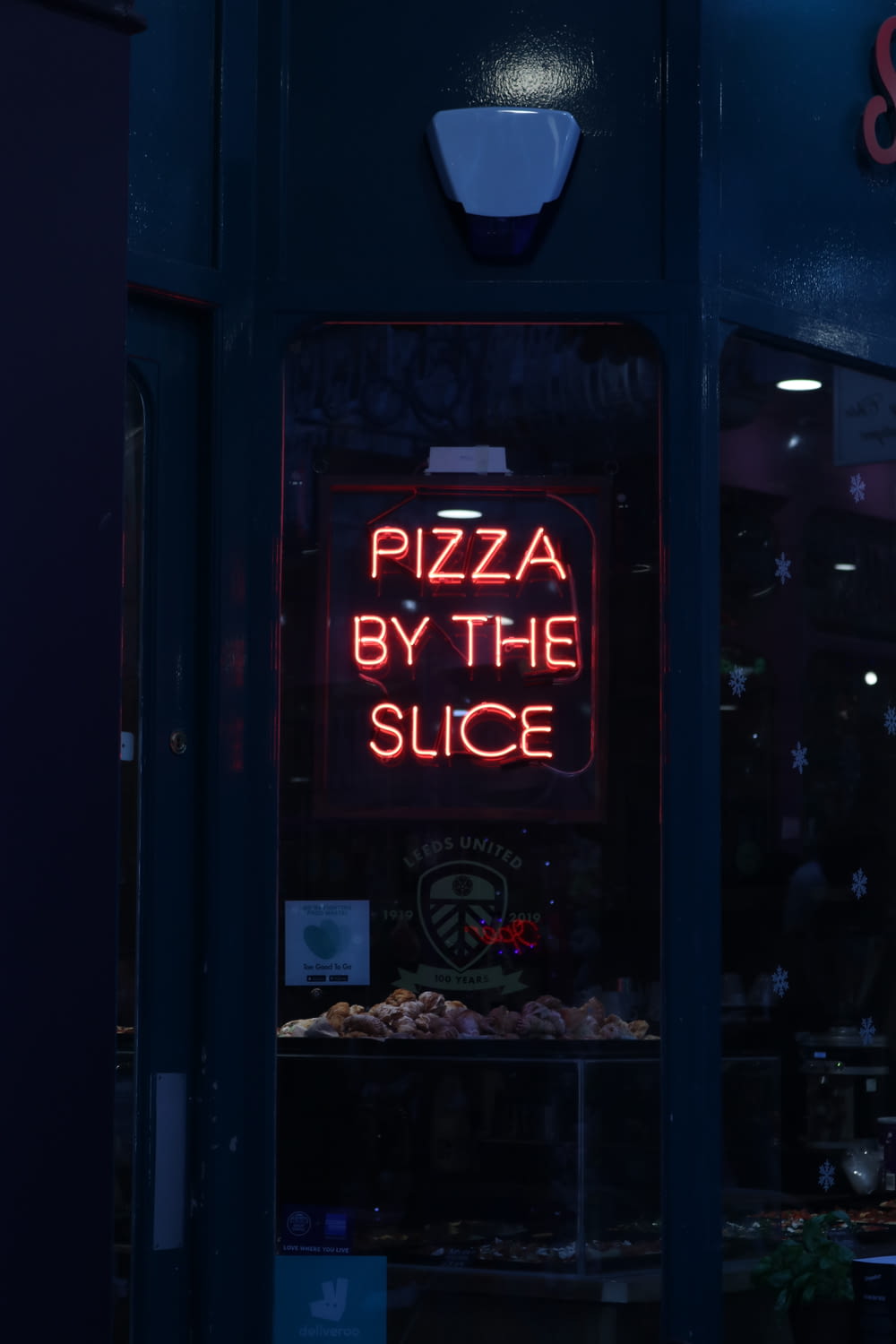 Pizza By the Slice neon signage