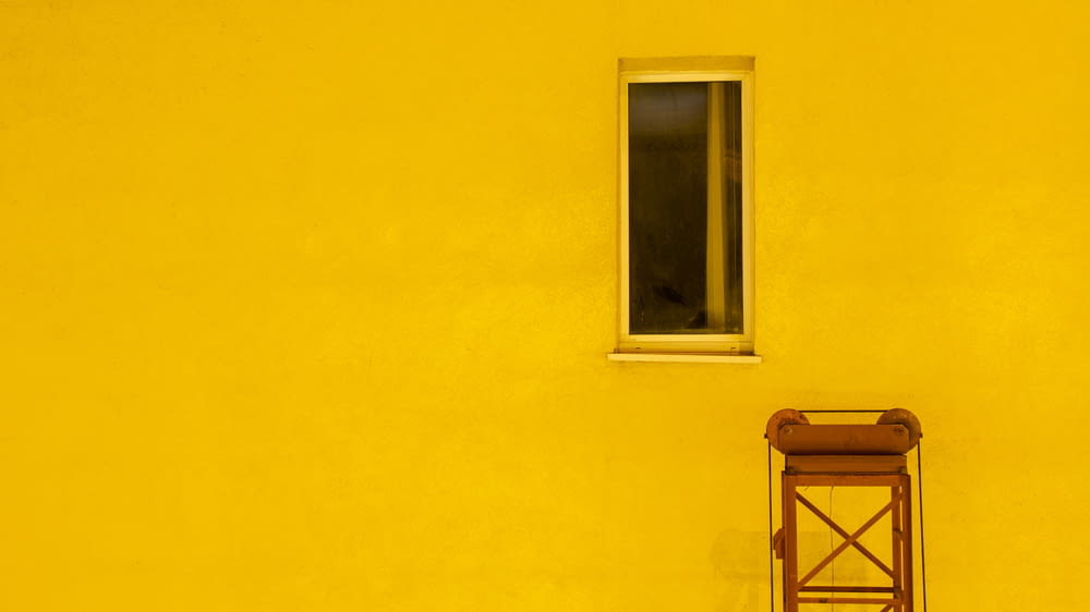 yellow painted house with window