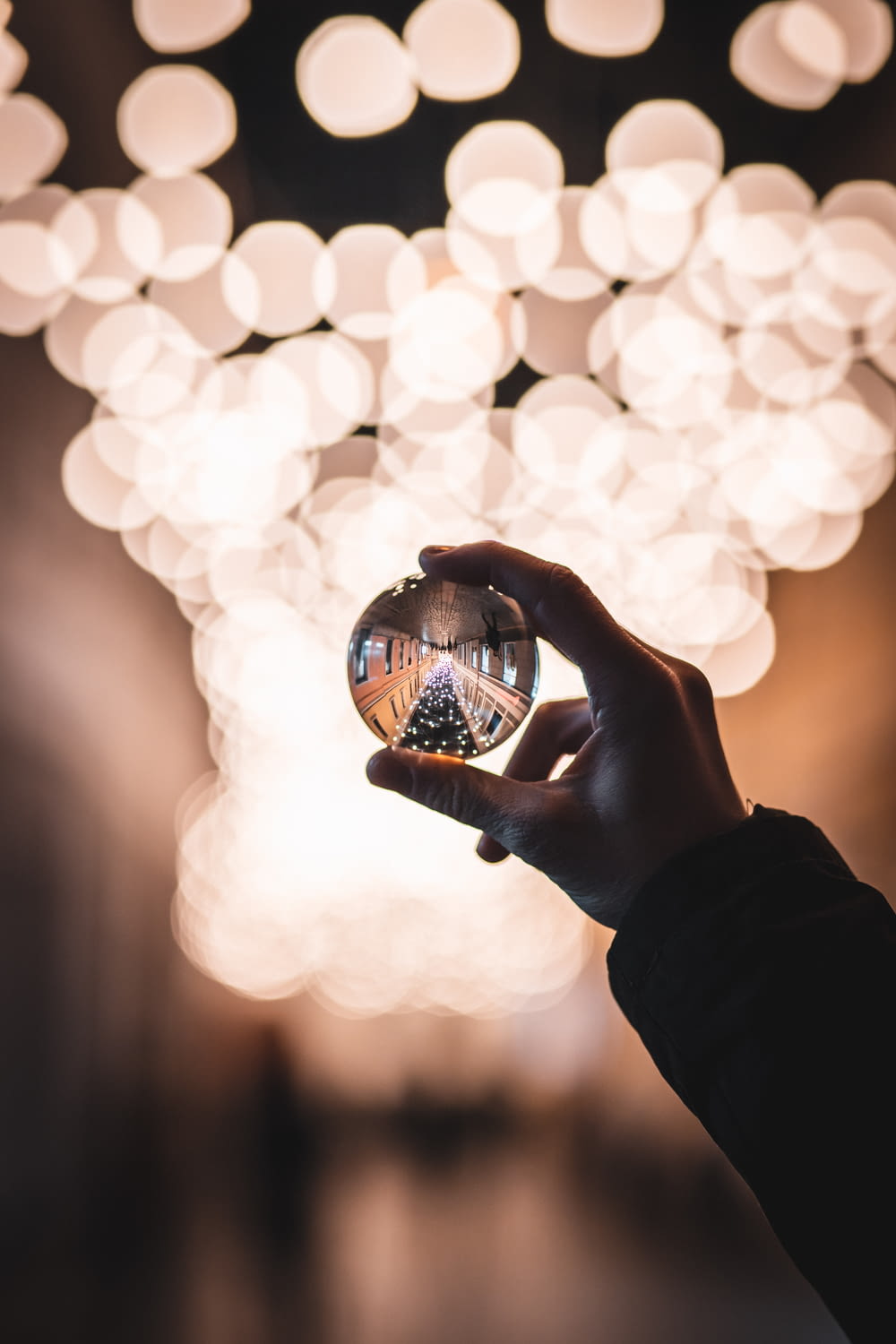 person holding glass sphere