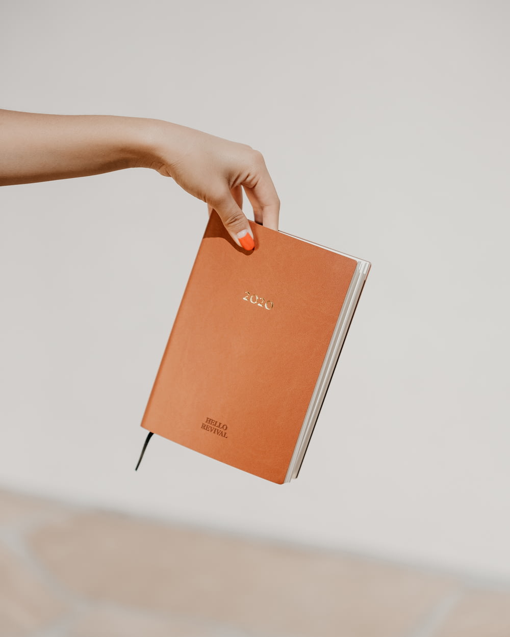 person holding brown book