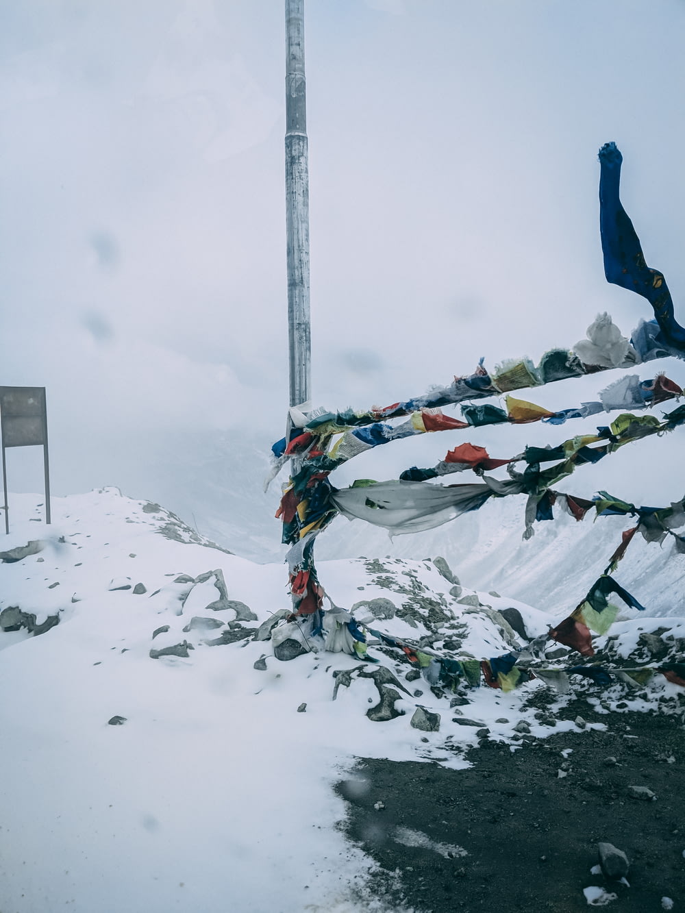 multicolored pennant flags on post near field covered with snow