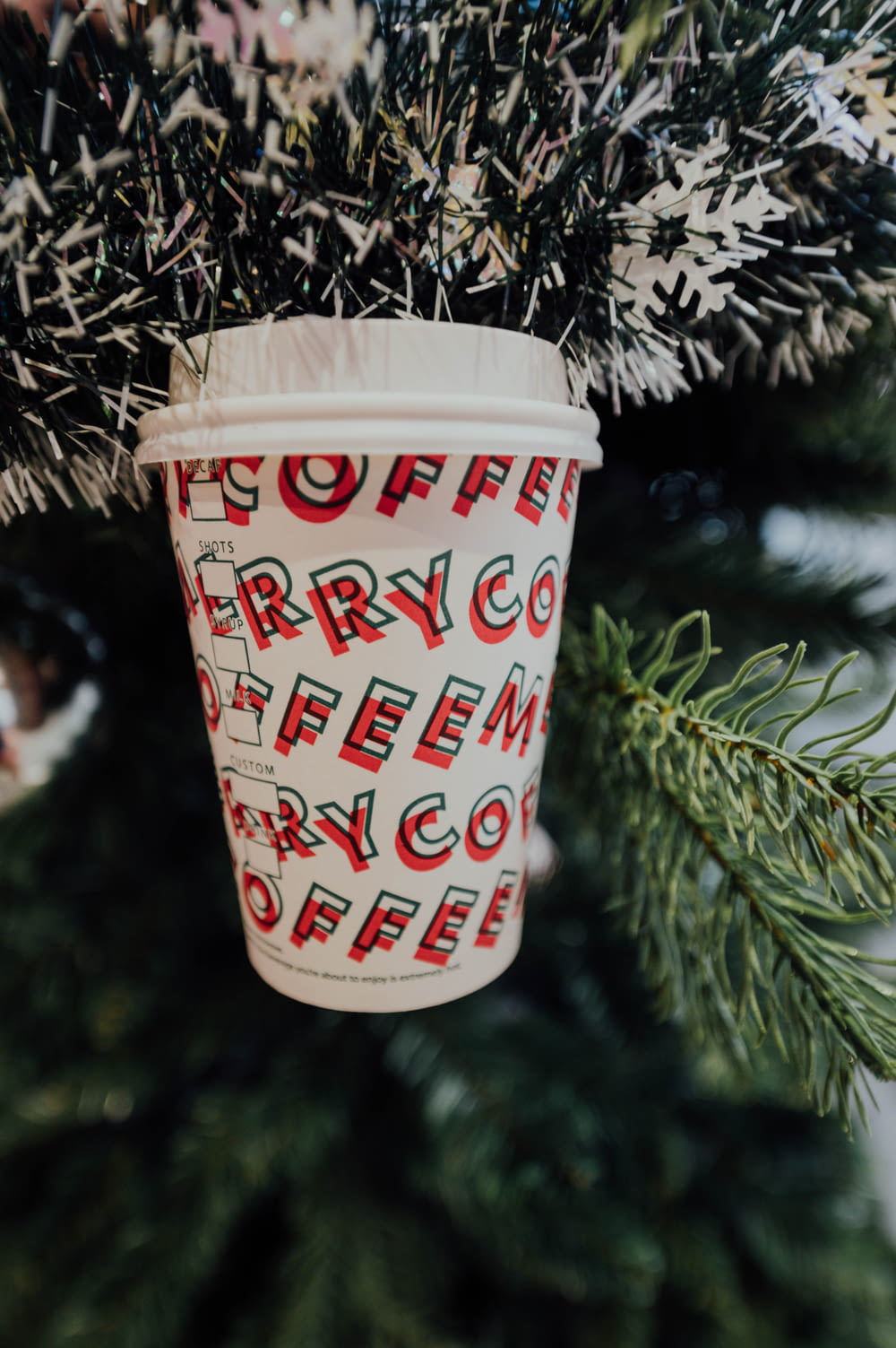 white and red coffee printed disposable cup
