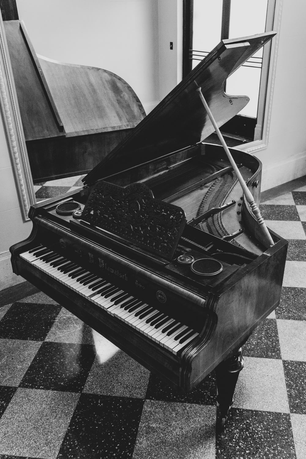 greyscale photo of grand piano