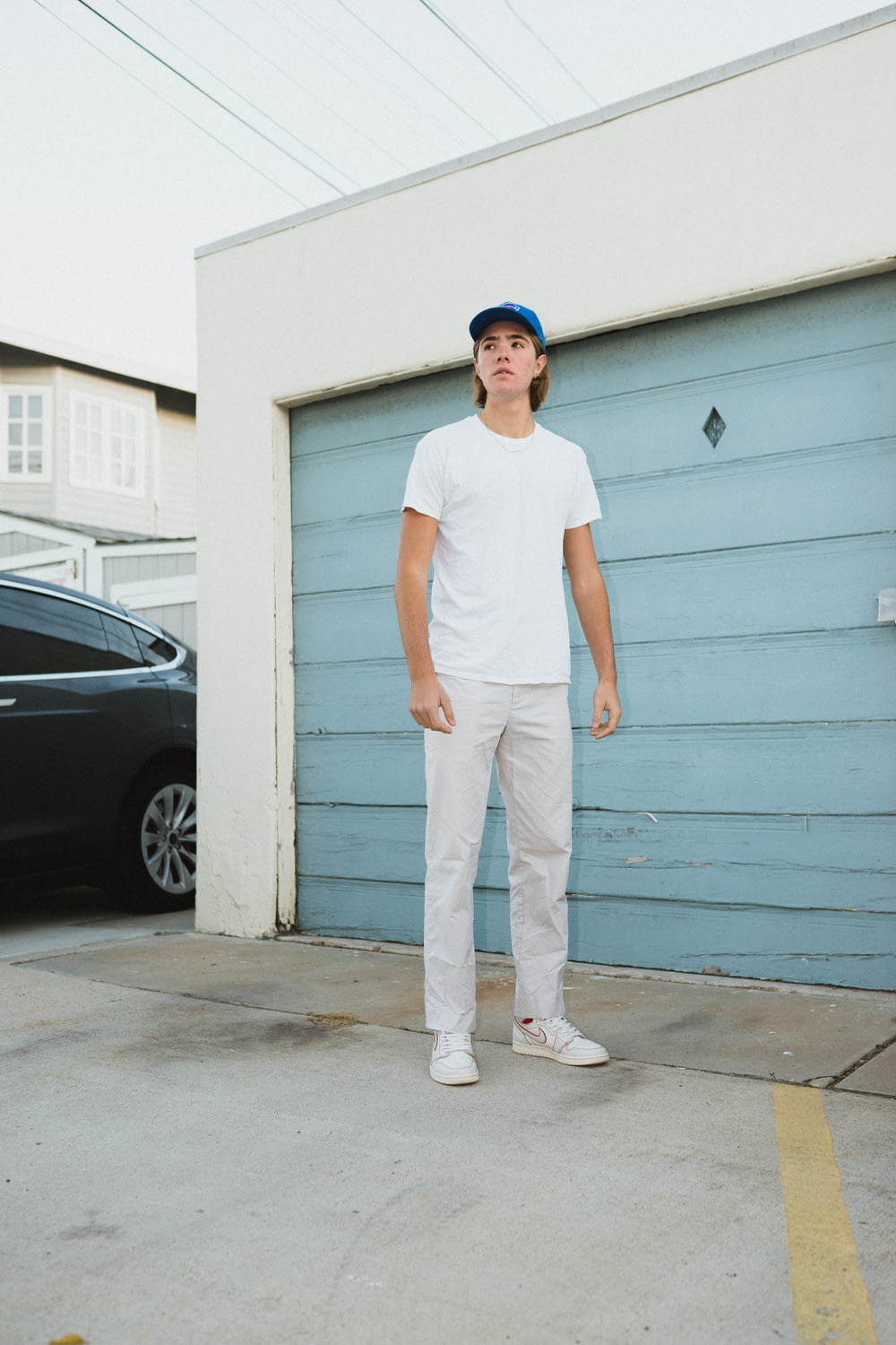 man standing in front of closed garage