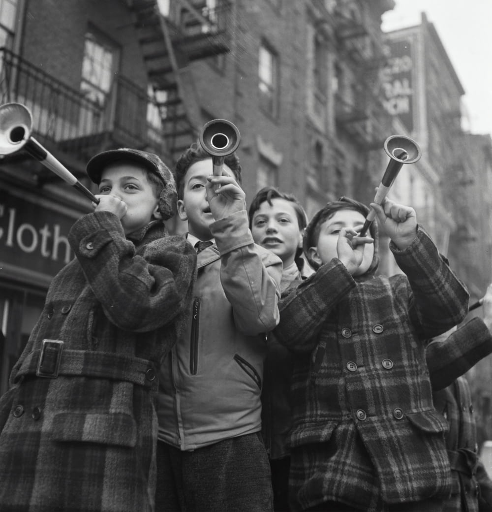 Blowing horns on Bleeker Street on New Year's Day. 