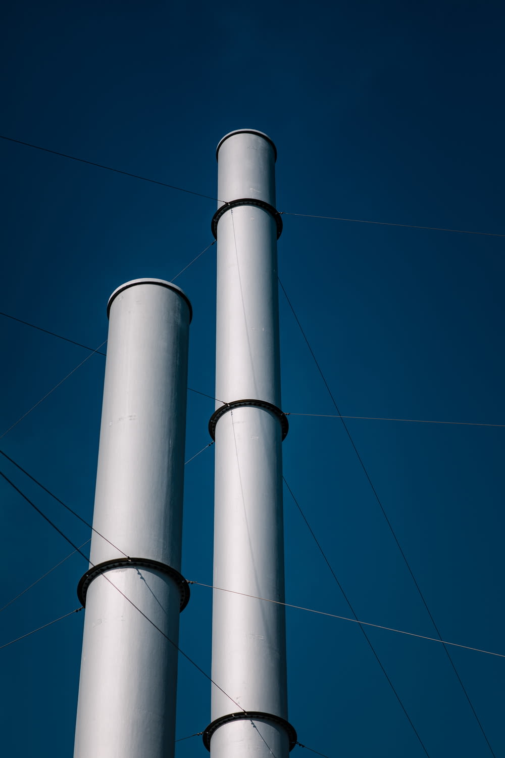 a couple of tall white poles sitting next to each other