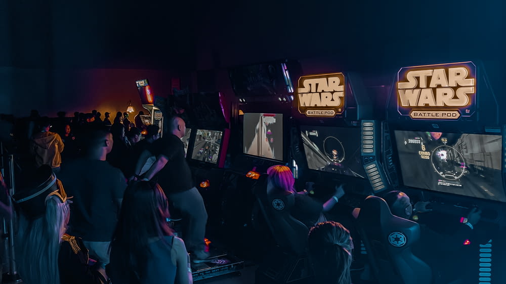 people inside building with Star Wars arcade machine
