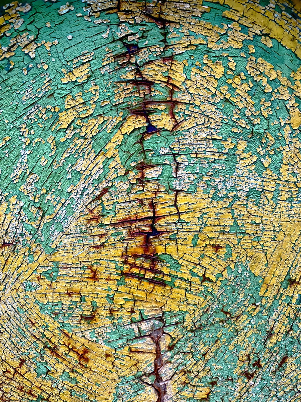 a close up of a piece of wood with yellow and green paint