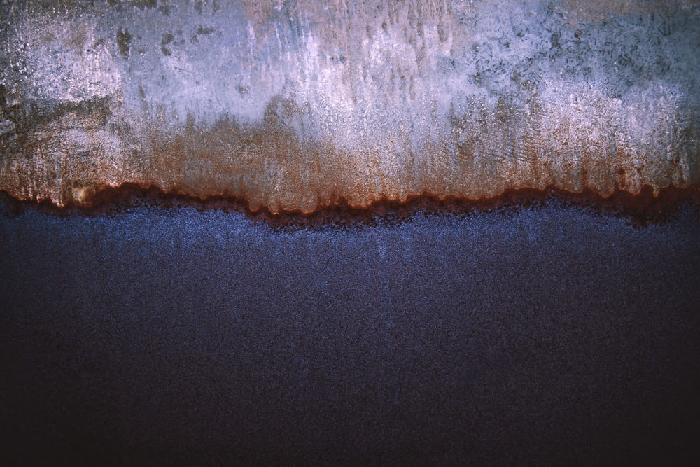 an abstract painting of blue and brown colors