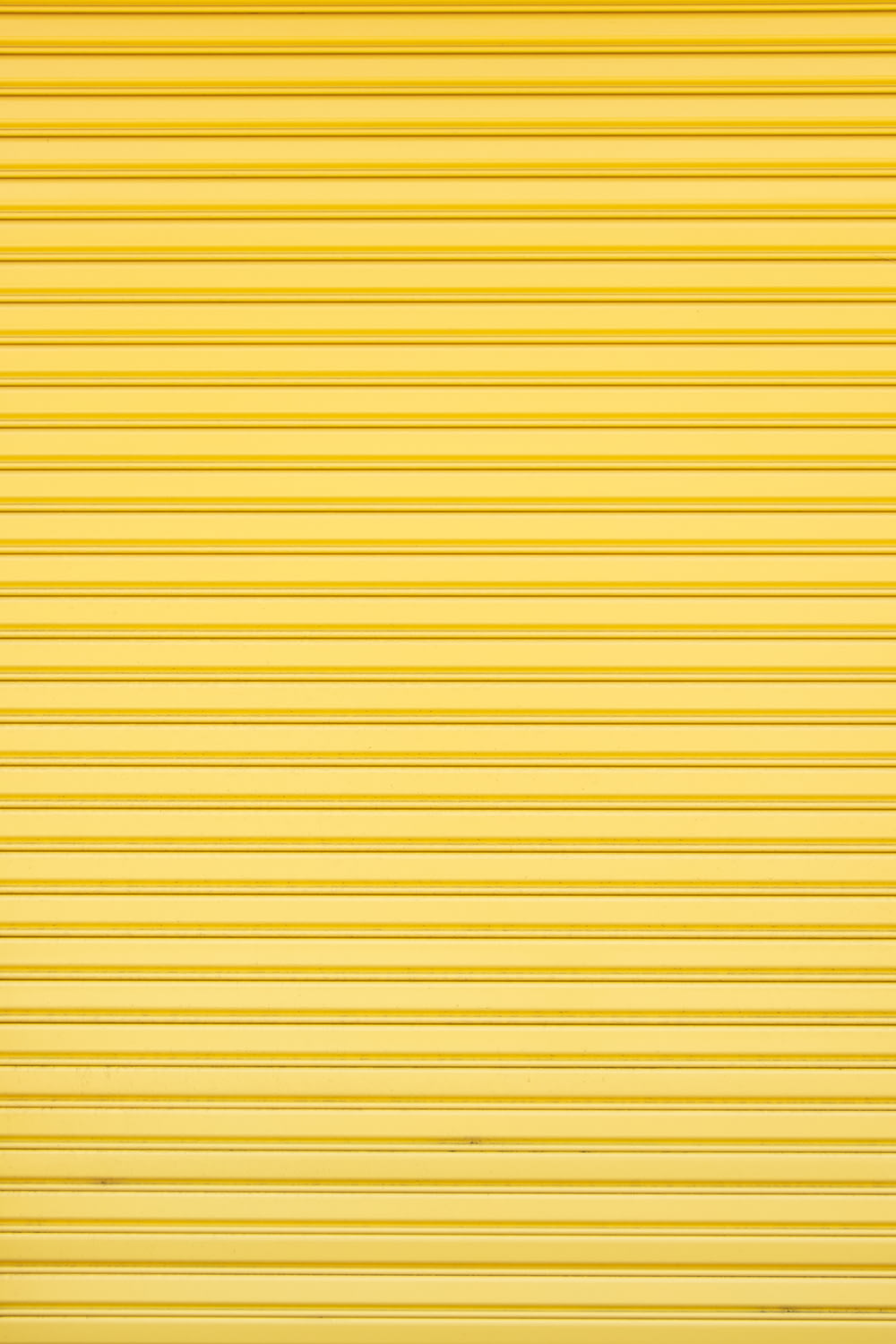 a yellow garage door that is closed