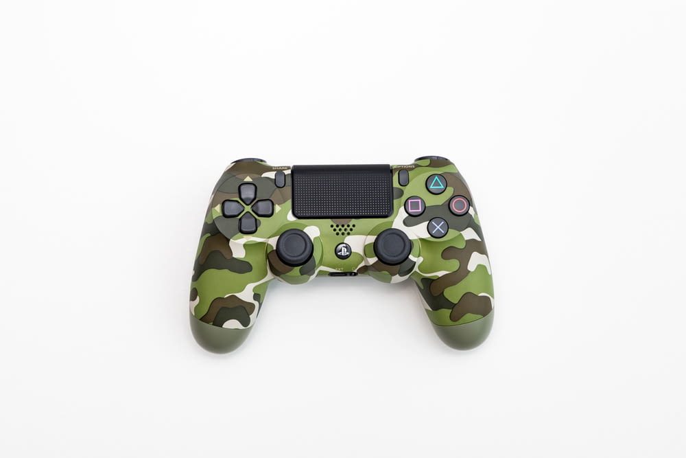 green, black, and white camouflage Sony DualShock 4 wireless controller
