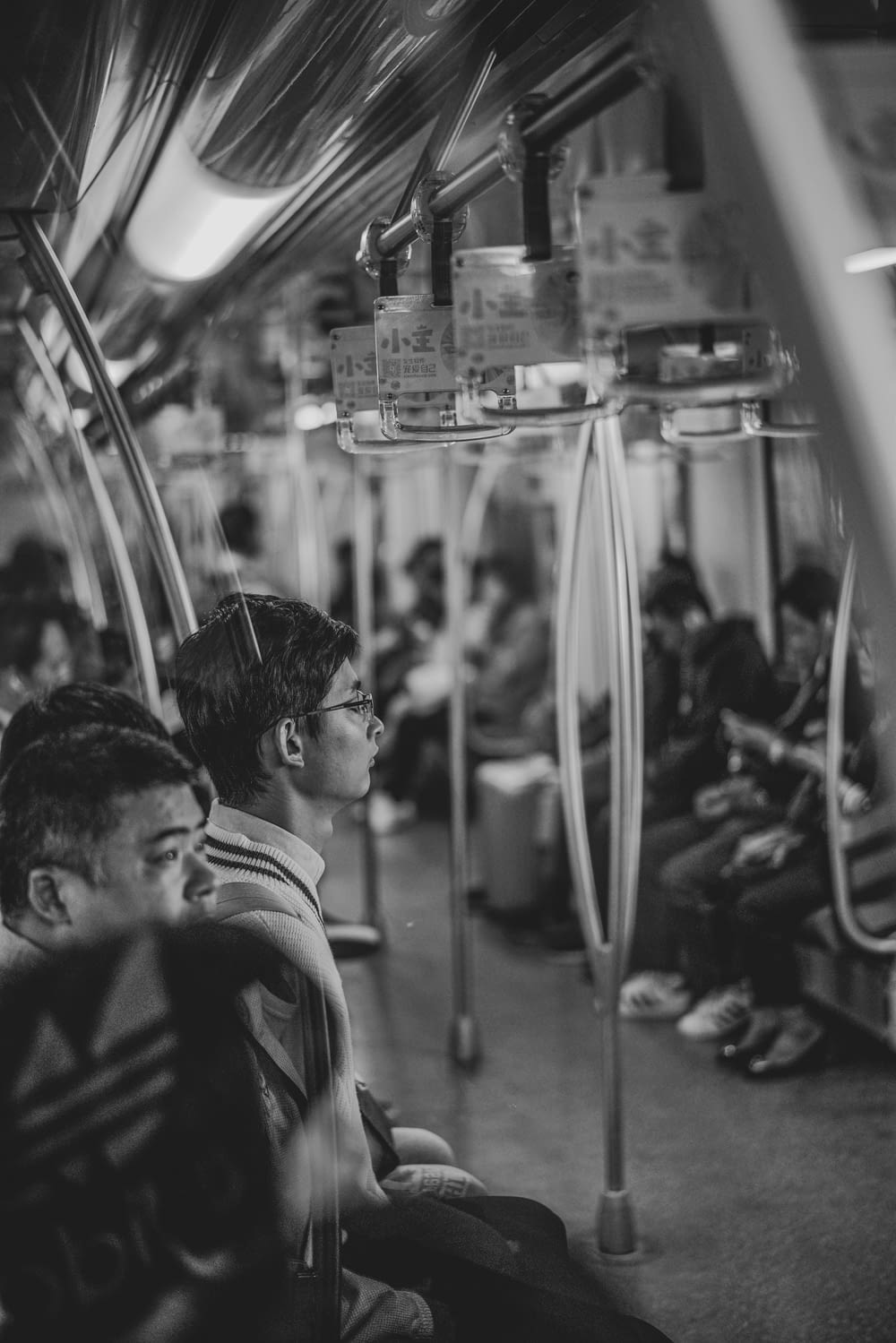 grayscale photography of people inside train