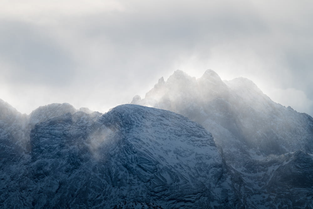 aerial photography of mountain covered with snow in foggy day