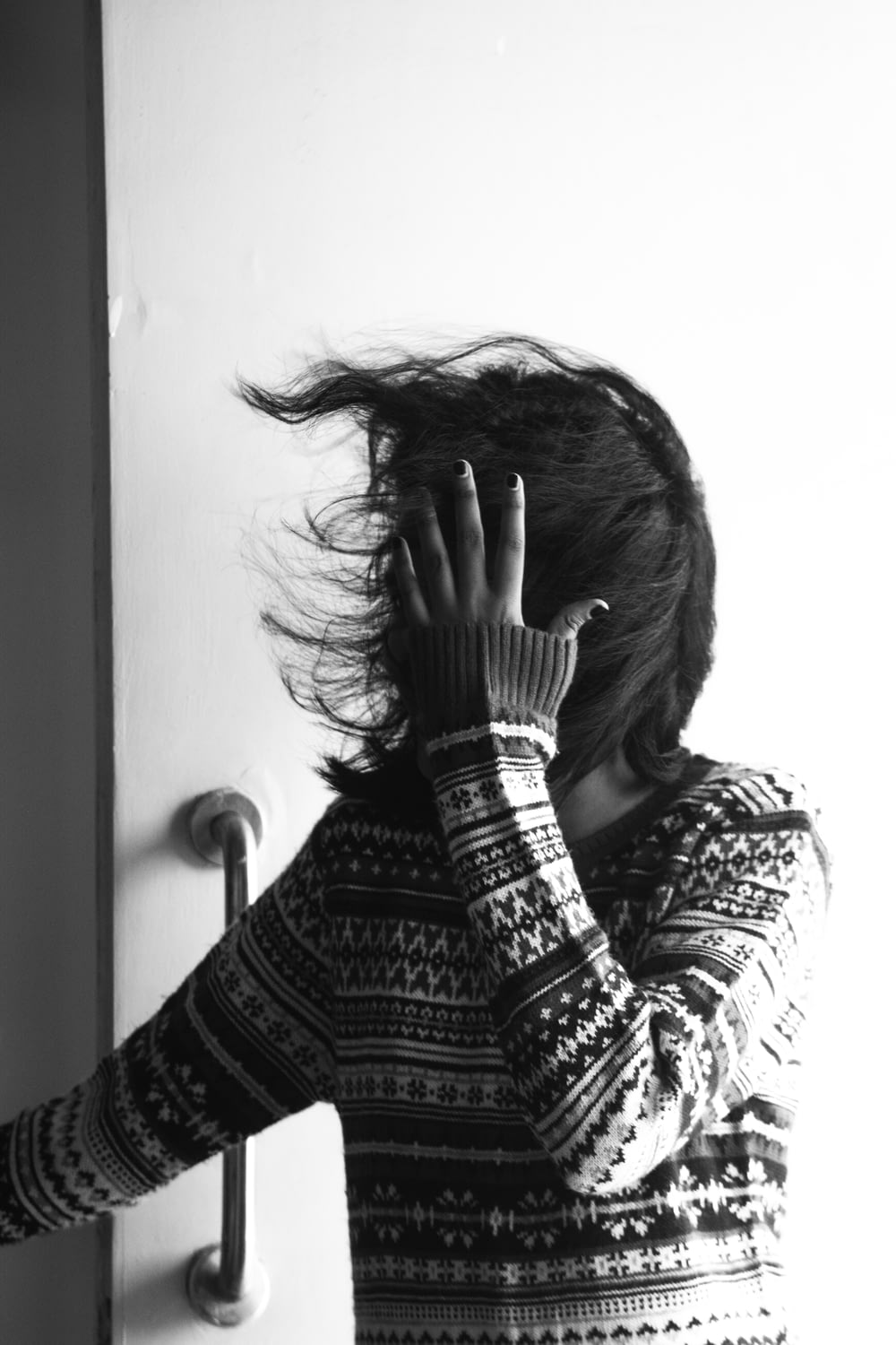 grayscae photo of woman in sweater