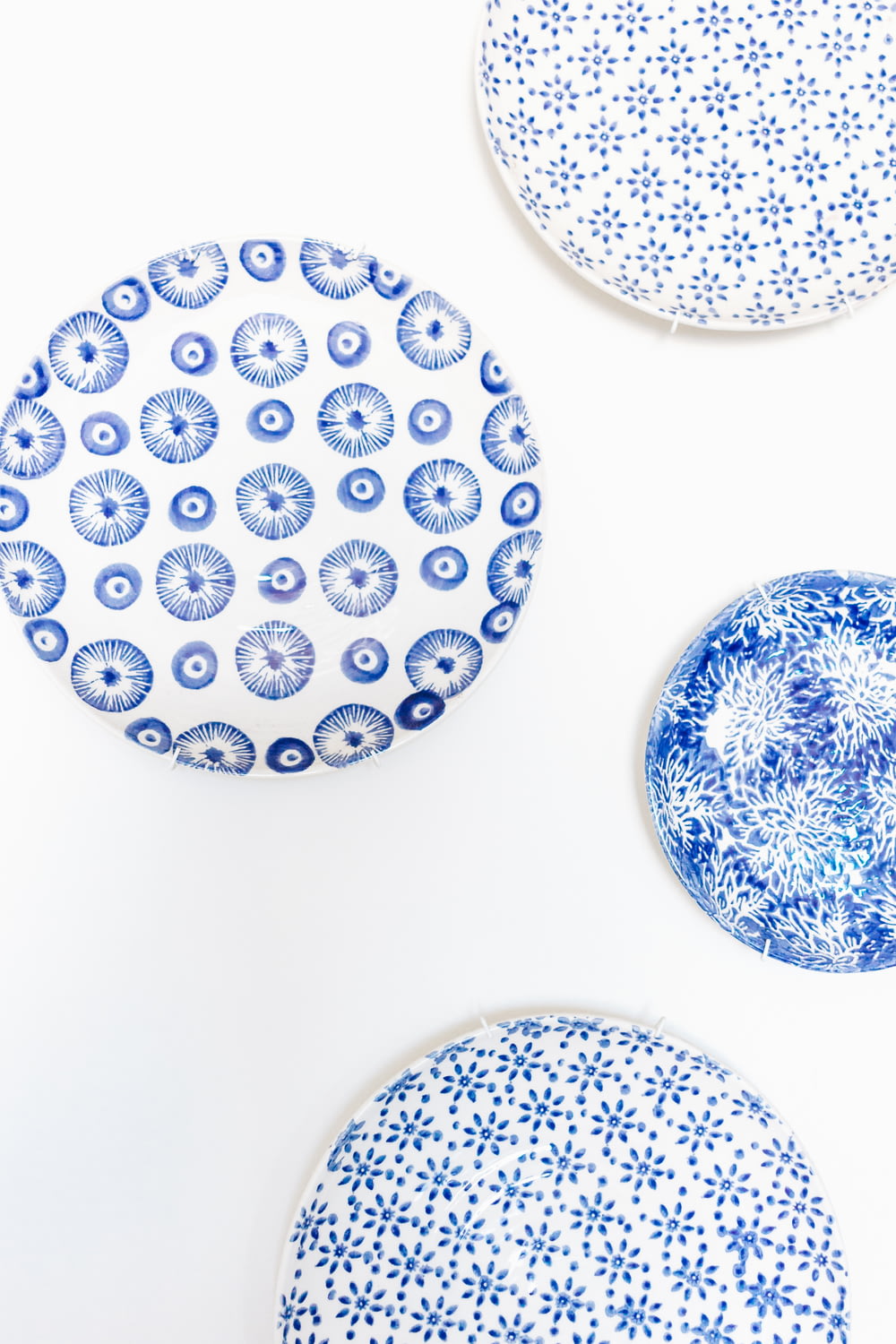 three blue and white plates sitting on top of a table