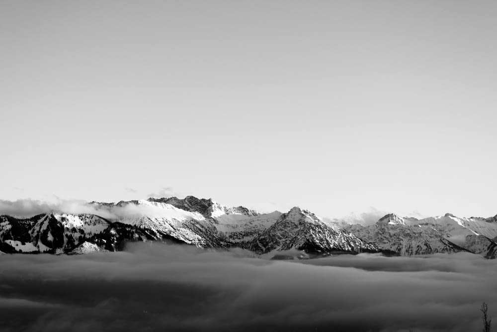 grayscale photography of summit of mountain
