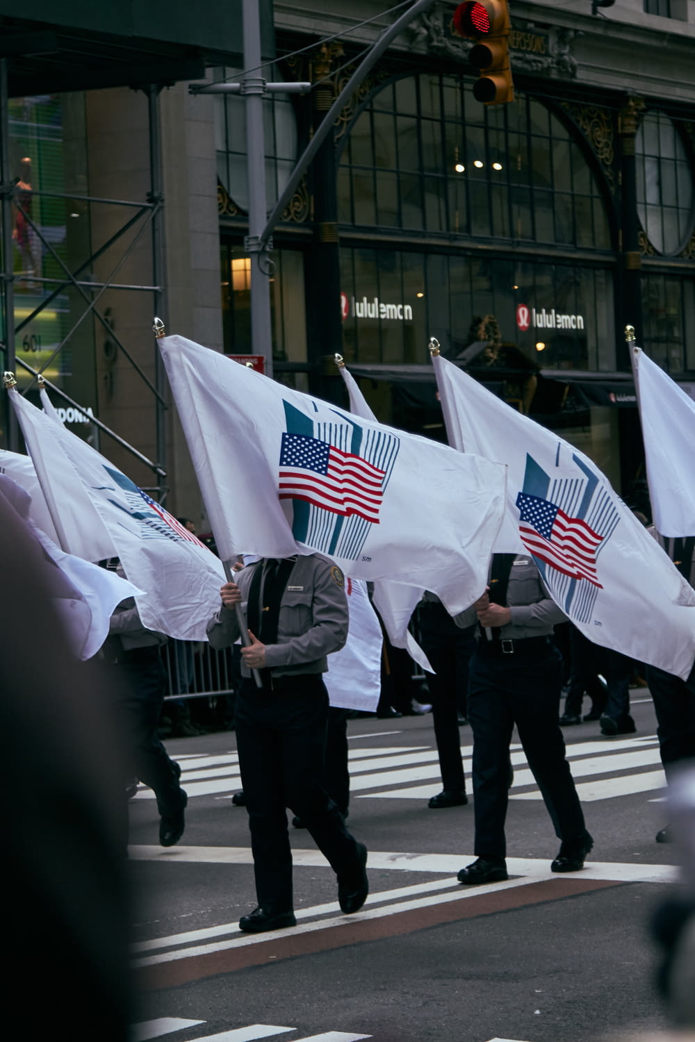 walking solider holding US flag with high-rise buildings background banners