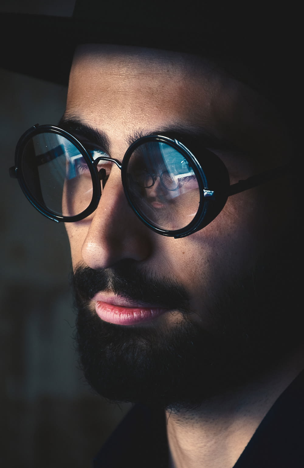 selective focus photography of man wearing black framed eyeglasses