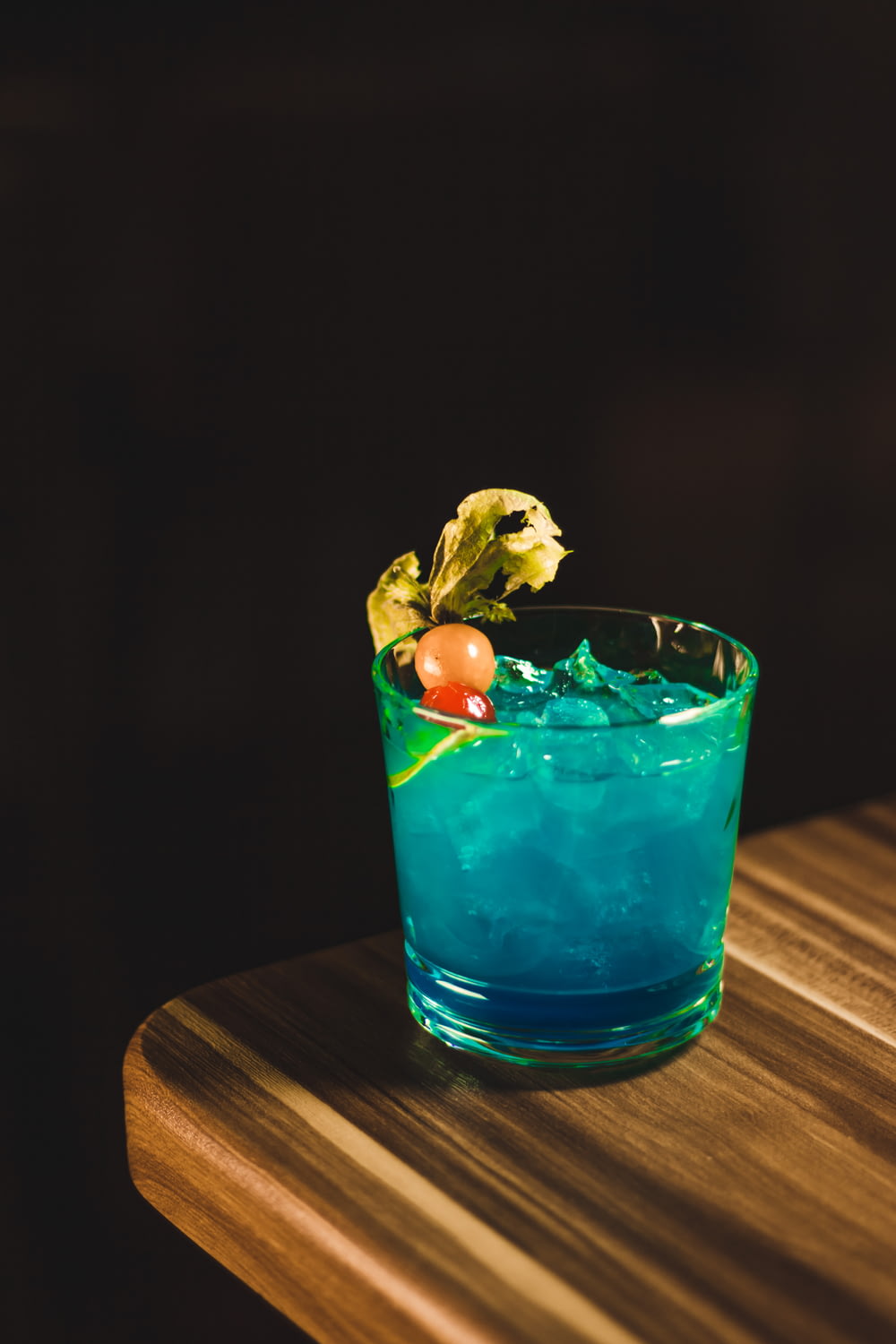 Un cocktail bleu assis sur une table en bois