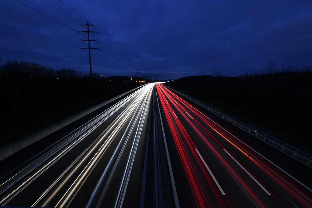 time lapse photography of vehicles travelling on road