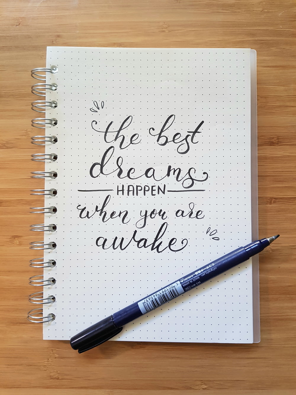 the best dreams happen when you are awake notebook and black pen