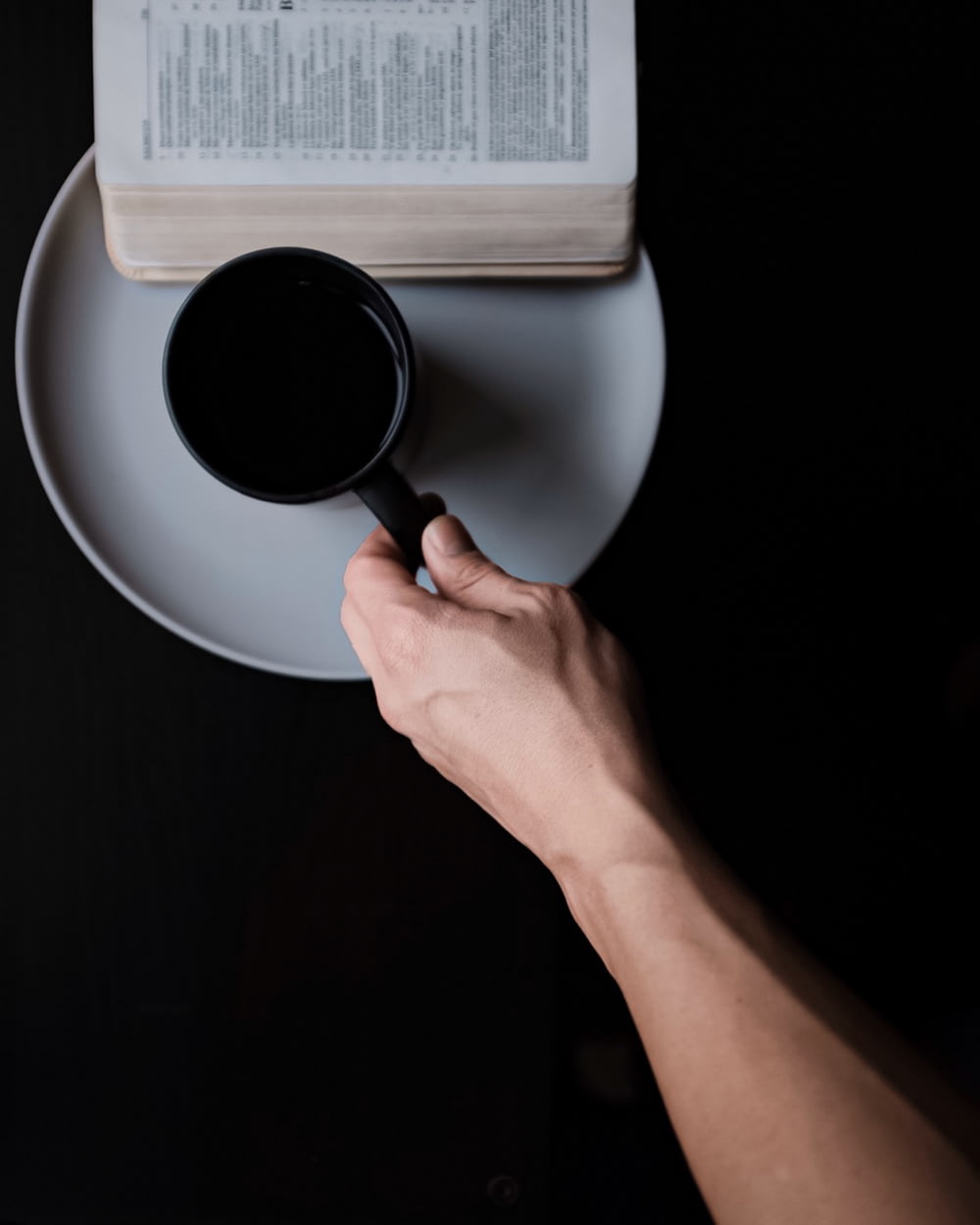 person holding mug of coffee