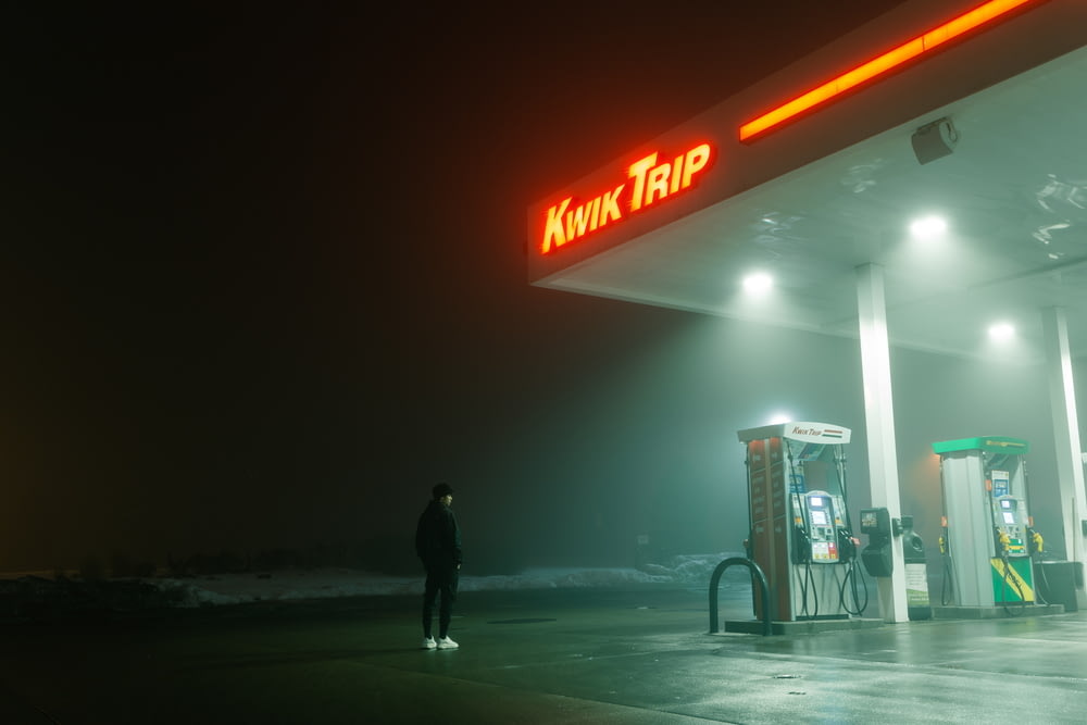 man standing near Kwik Trip gas station