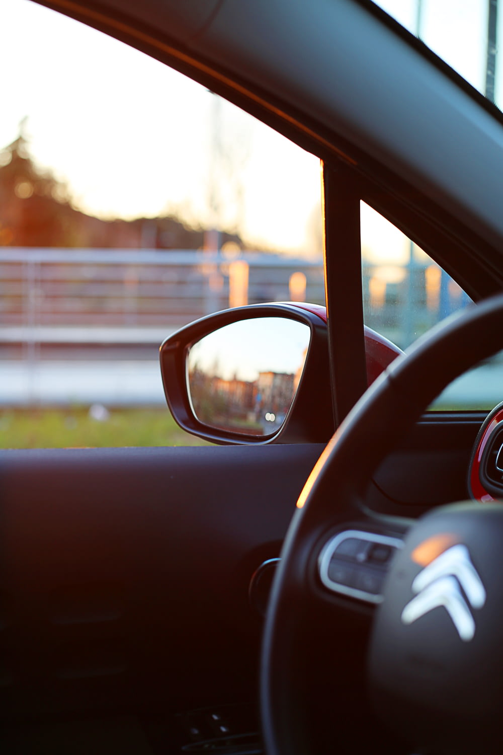 black Citroen car steering wheel and side mirror