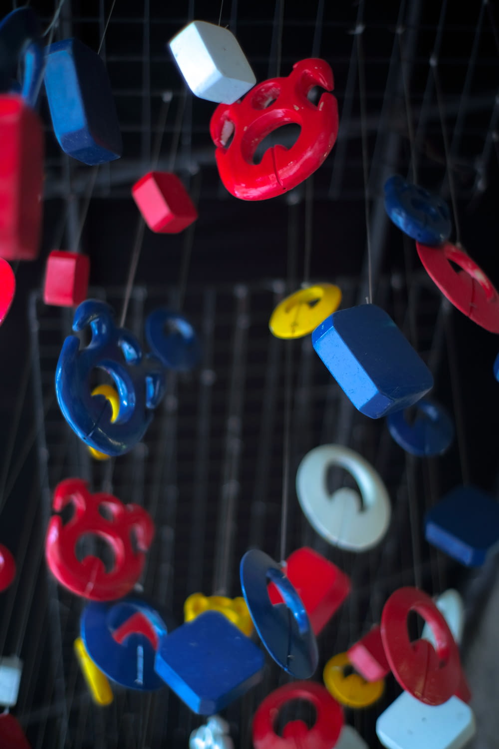 blue, red, and yellow plastic hanging toys