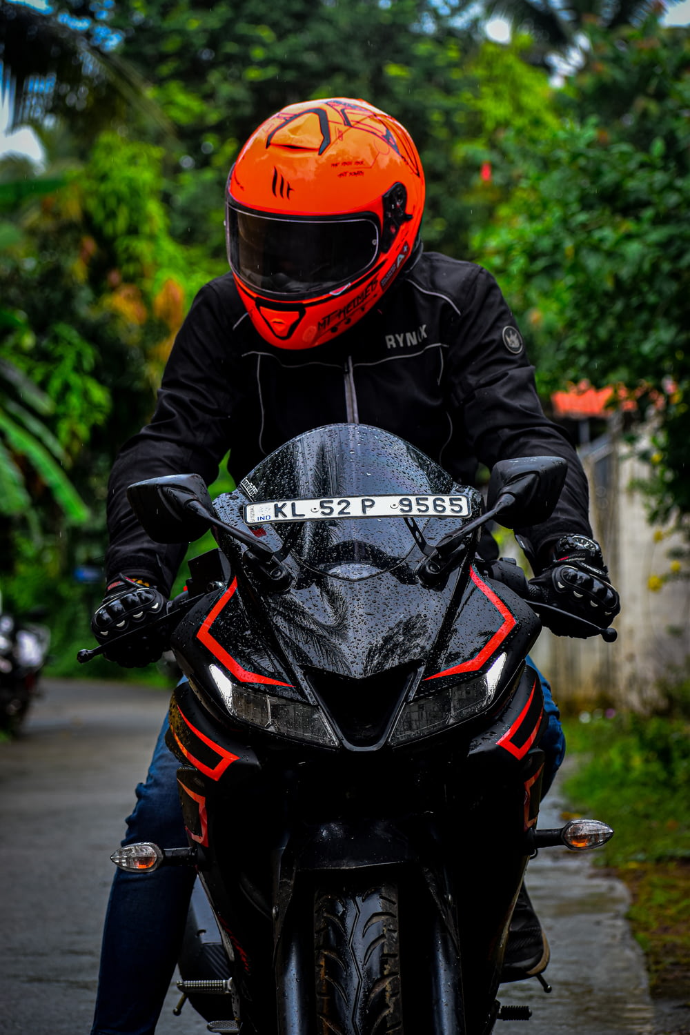 person in black and red motorcycle helmet and black jacket