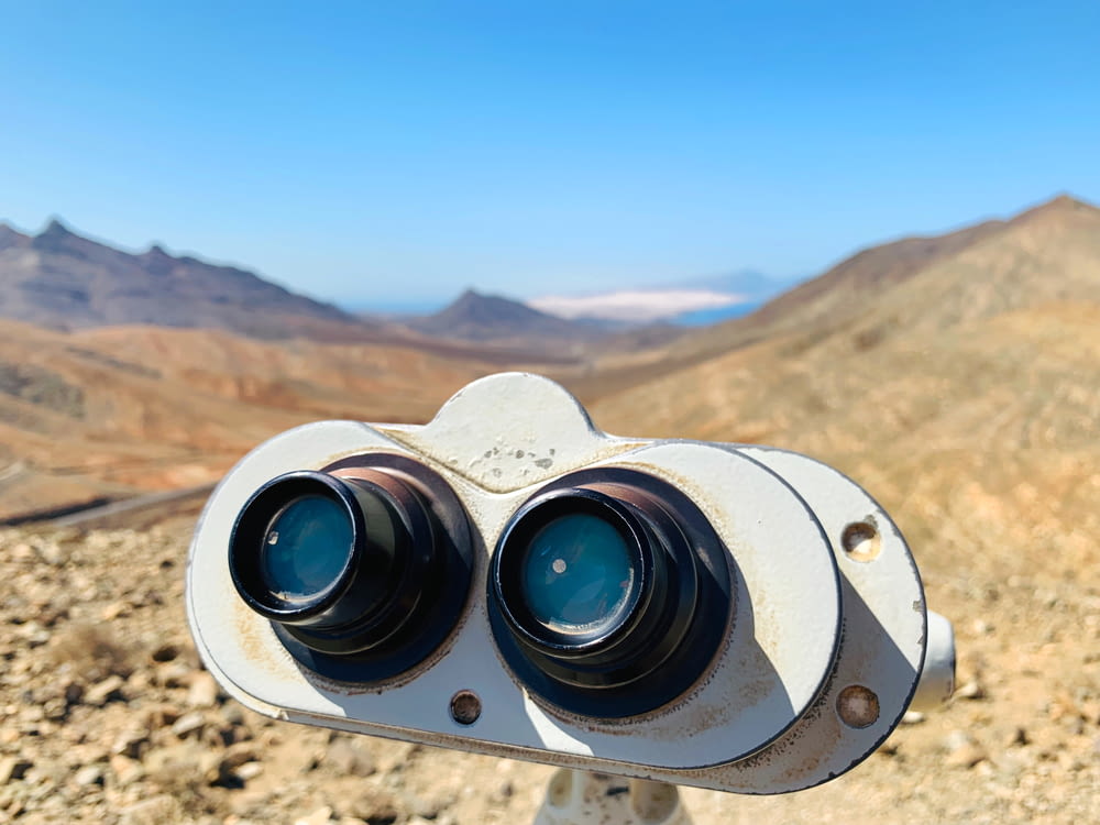 white binoculars on brown rock formation during daytime