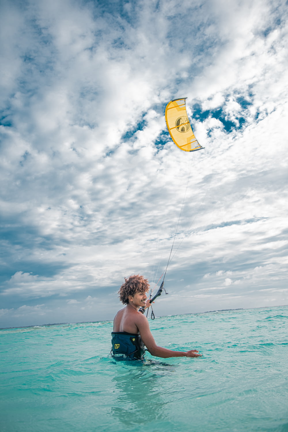 a person in the water with a kite