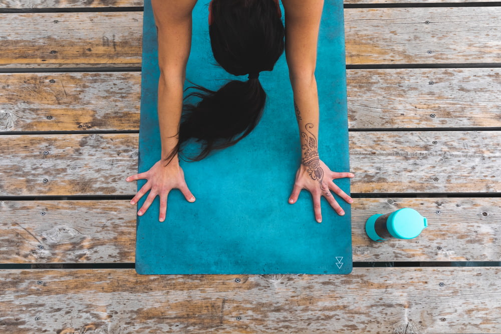 a woman is doing yoga on a mat