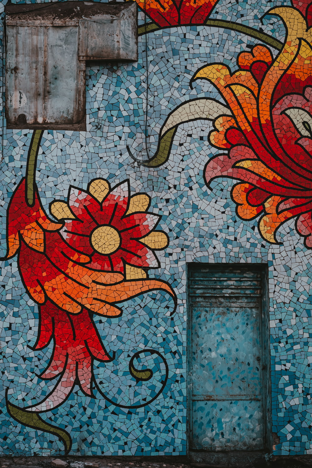 a painting of flowers painted on the side of a building