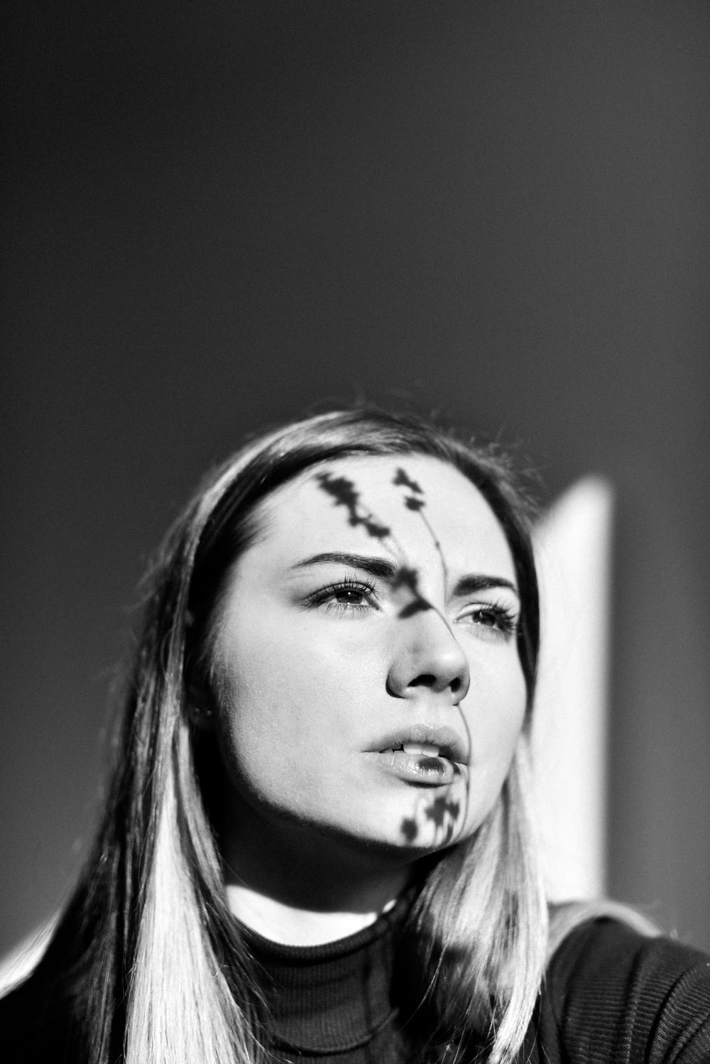 grayscale photo of woman with face paint