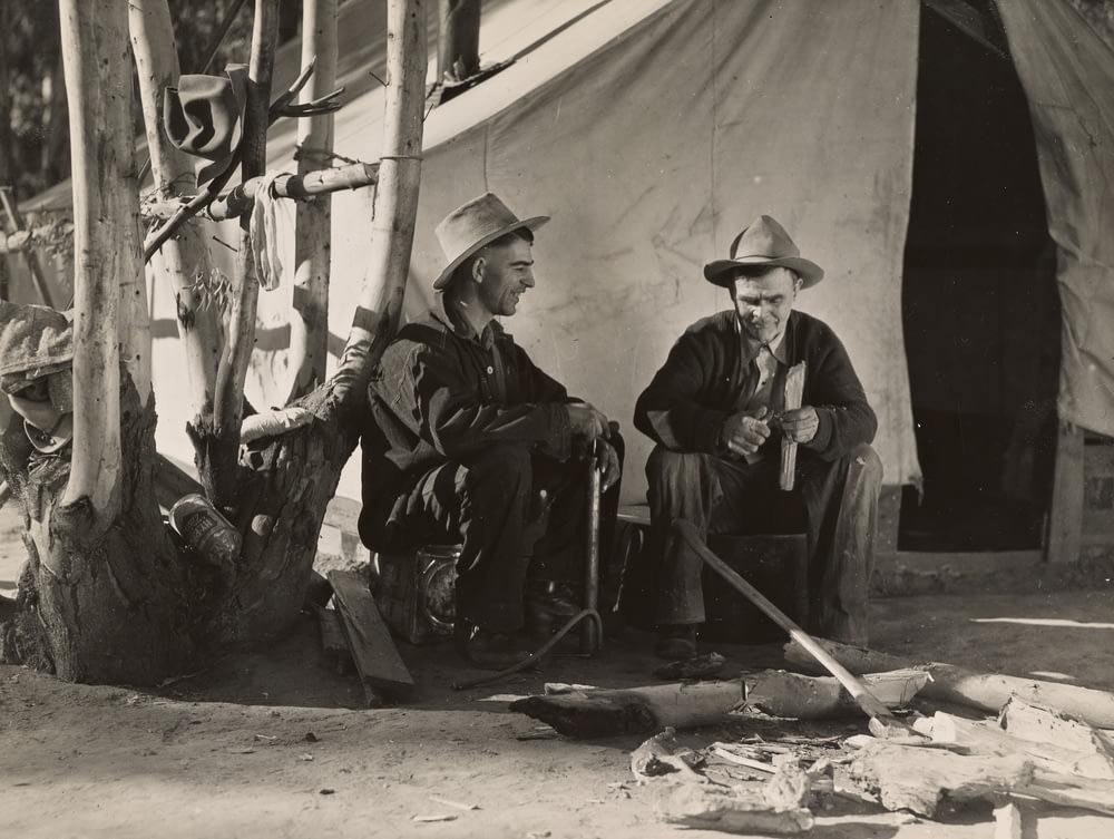 grayscale photo of 2 men wearing cowboy hats