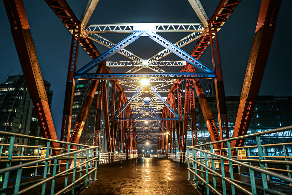 red metal bridge during night time