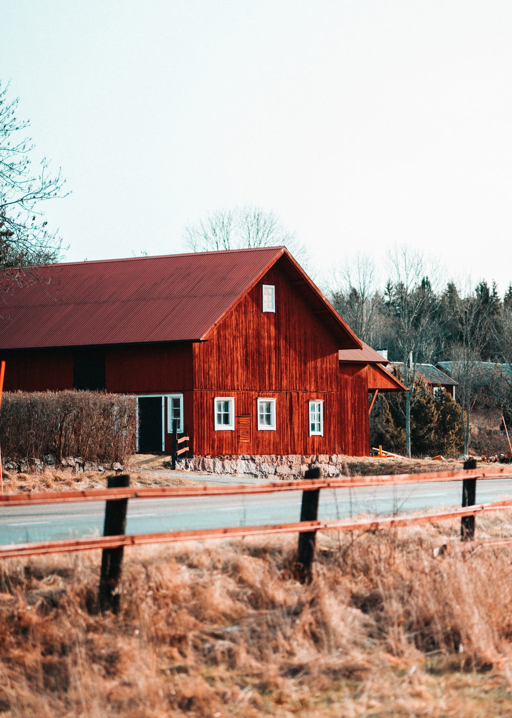 a red barn sitting on the side of a road