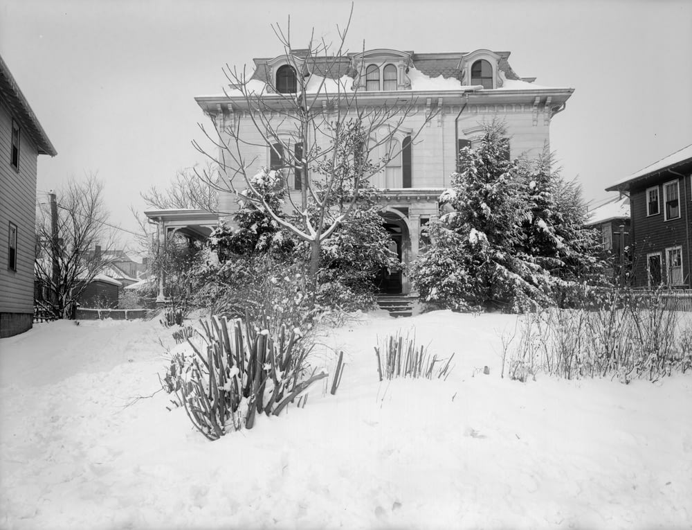 grayscale photo of house covered with snow