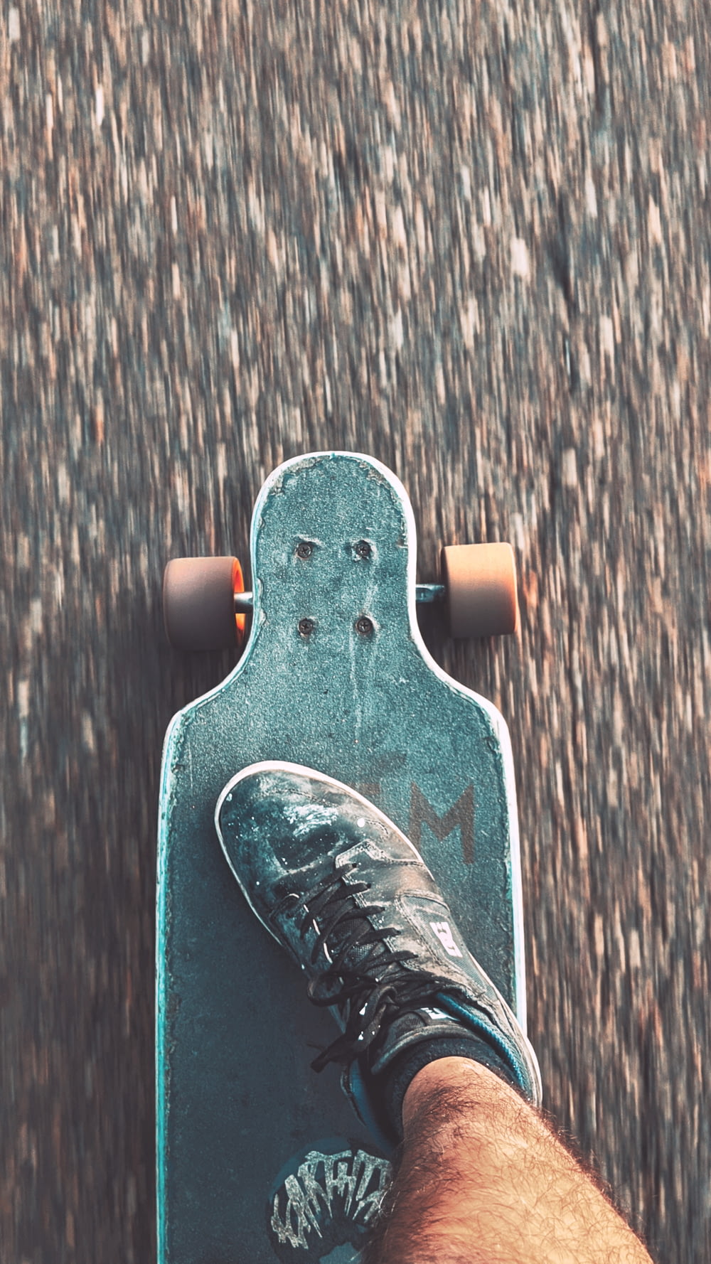 black and white skateboard on brown wooden floor