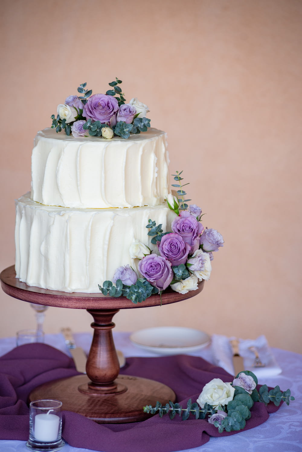 white cake with pink roses on top