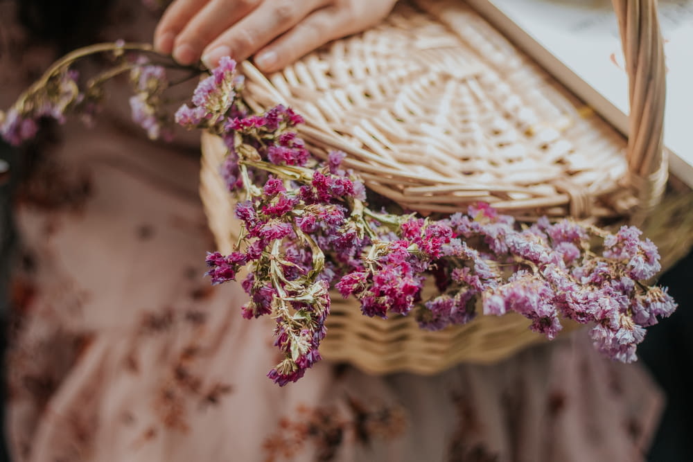 purple flowers on brown woven basket