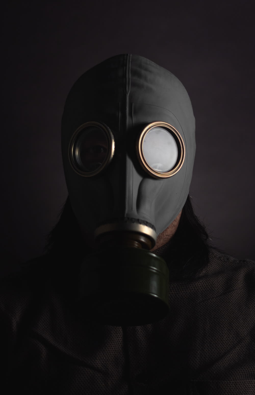 person wearing black gas mask