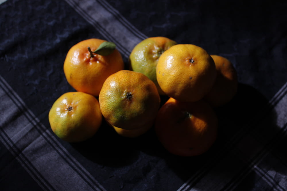 yellow round fruits on brown wooden table