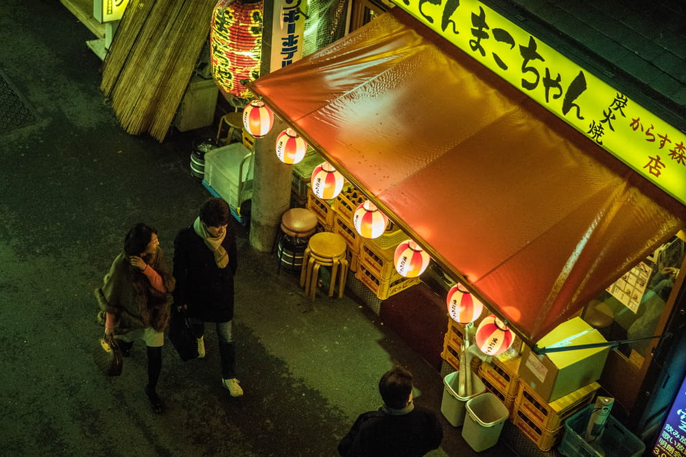 people standing near food stall during nighttime